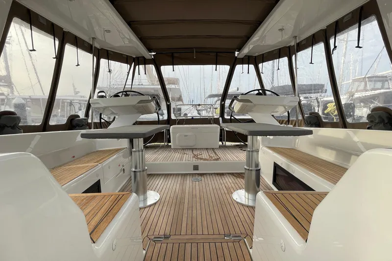  Yacht Photos Pics Interior view of 2018 Hanse 588 yacht with dual steering wheels and teak flooring.