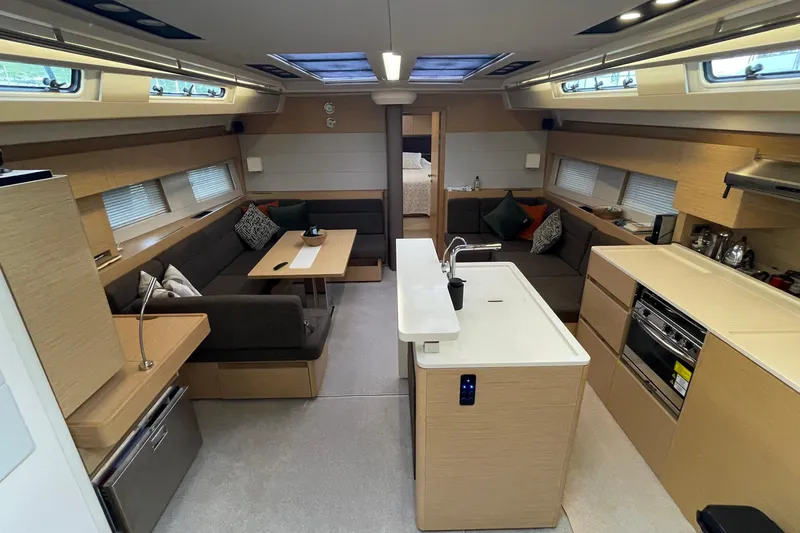  Yacht Photos Pics Luxurious interior of 2018 Hanse 588 yacht with modern kitchen and cozy seating area.