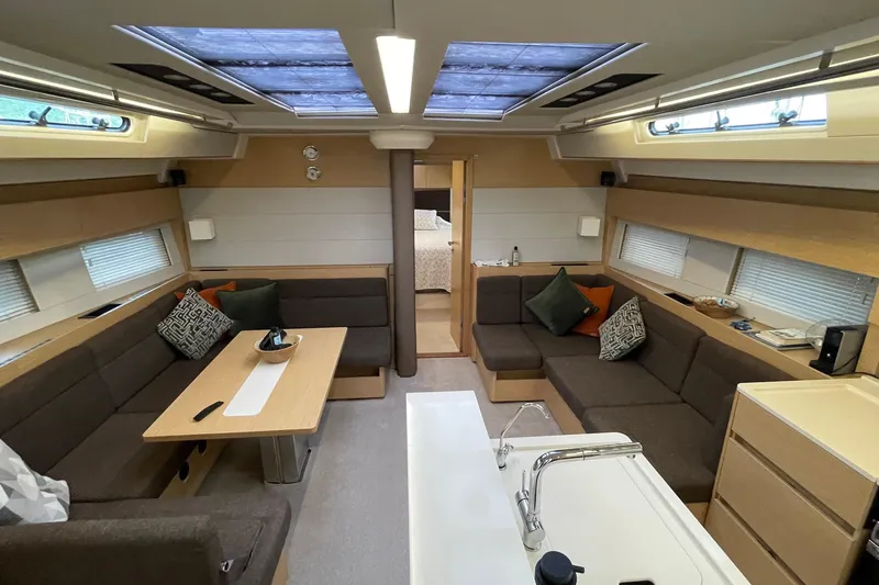  Yacht Photos Pics Luxurious interior of 2018 Hanse 588 yacht with modern seating and skylights.