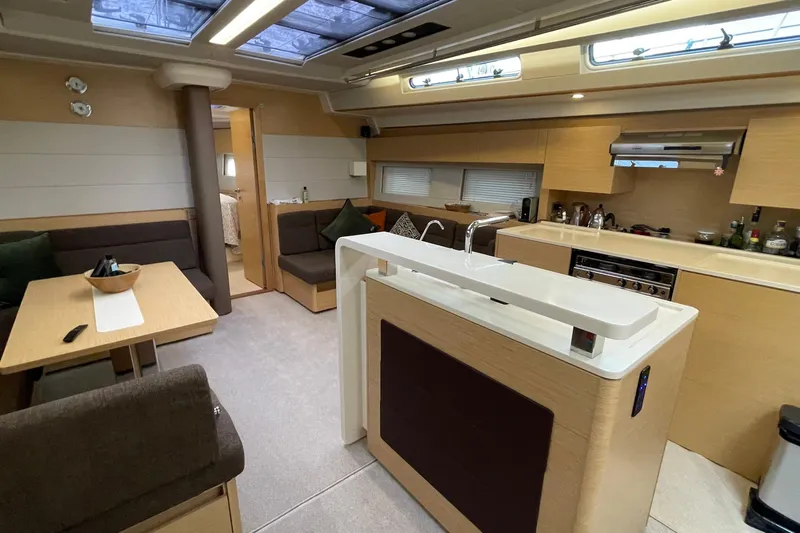  Yacht Photos Pics Luxurious interior of 2018 Hanse 588 yacht with modern kitchen and seating area.