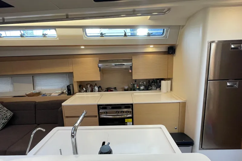  Yacht Photos Pics Modern kitchen interior of 2018 Hanse 588 yacht with sleek cabinetry and appliances.