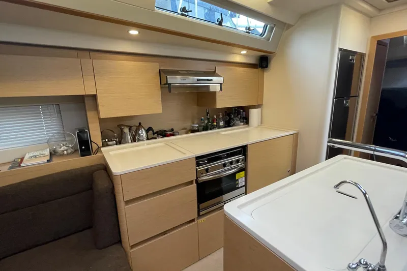  Yacht Photos Pics Modern kitchen interior of 2018 Hanse 588 yacht with sleek cabinetry and appliances.