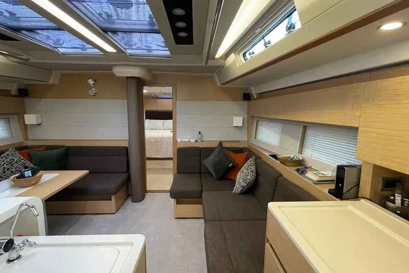  Yacht Photos Pics Luxurious interior of 2018 Hanse 588 yacht with modern seating and natural light.