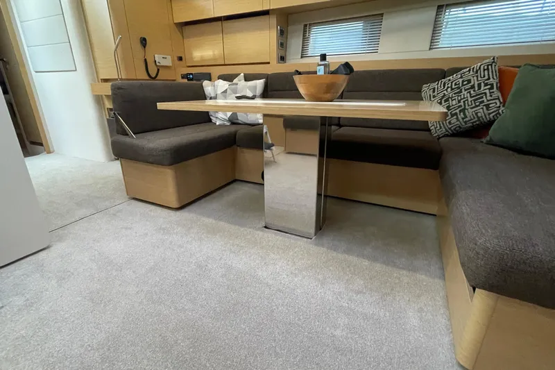  Yacht Photos Pics Luxurious interior of 2018 Hanse 588 yacht with modern seating and table.