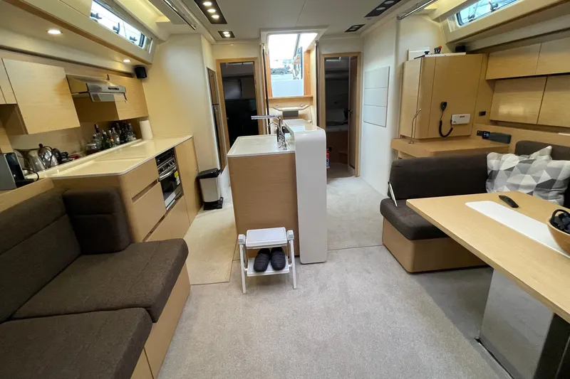  Yacht Photos Pics Luxurious interior of 2018 Hanse 588 yacht with modern kitchen and seating area.