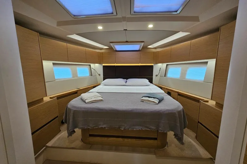  Yacht Photos Pics Luxurious cabin interior of 2018 Hanse 588 yacht with skylights and modern wood finish.