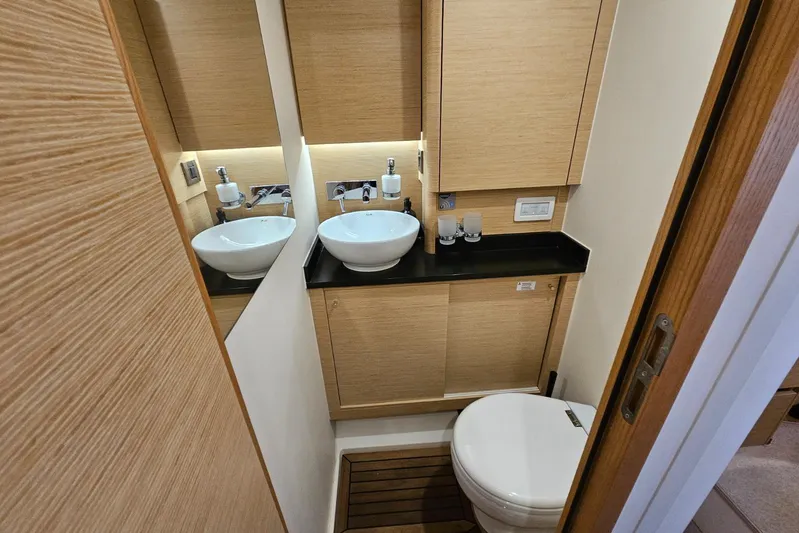  Yacht Photos Pics Modern bathroom in 2018 Hanse 588 yacht with sleek fixtures and wooden accents.