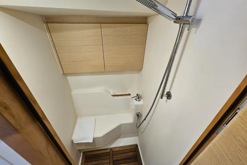  Yacht Photos Pics Modern shower area in 2018 Hanse 588 yacht with wooden accents and sleek fixtures.
