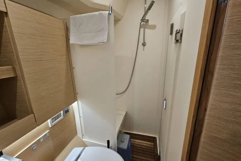  Yacht Photos Pics Interior of 2018 Hanse 588 yacht bathroom with shower and wooden accents.