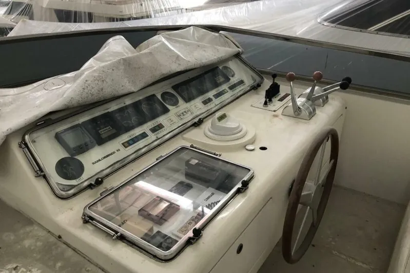  Yacht Photos Pics Control panel of a 1998 Sanlorenzo 82 yacht, featuring navigation instruments and steering wheel.