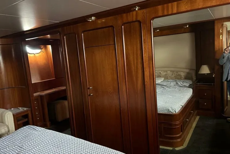  Yacht Photos Pics Luxurious wooden interior of 1998 Sanlorenzo 82 yacht cabin with bed and desk.