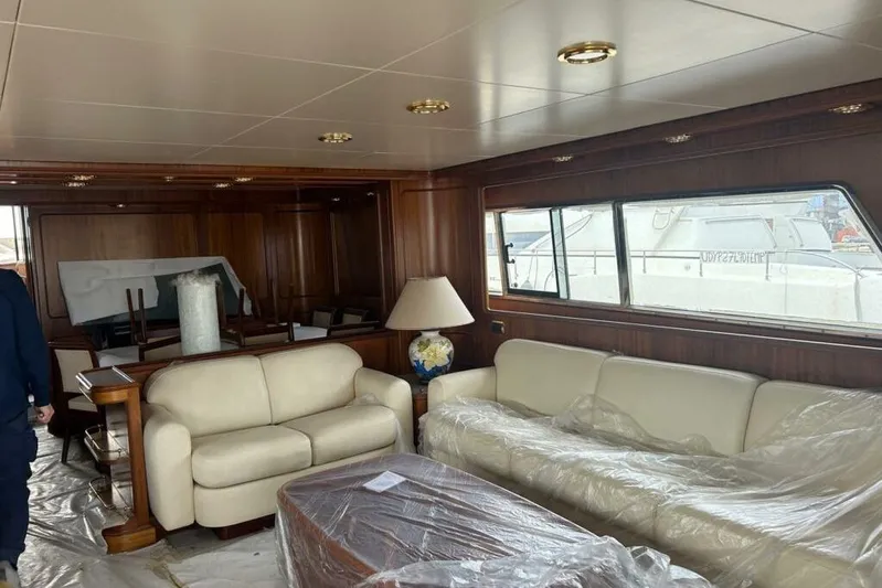  Yacht Photos Pics Luxurious interior of 1998 Sanlorenzo 82 yacht with elegant seating and wooden accents.