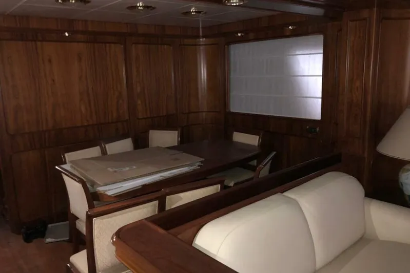  Yacht Photos Pics Luxurious wooden interior of a 1998 Sanlorenzo 82 yacht with dining area.