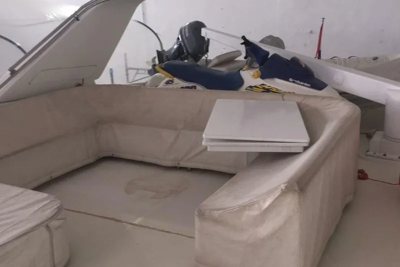  Yacht Photos Pics Luxurious seating area on 1998 Sanlorenzo 82 yacht with a jet ski in the background.