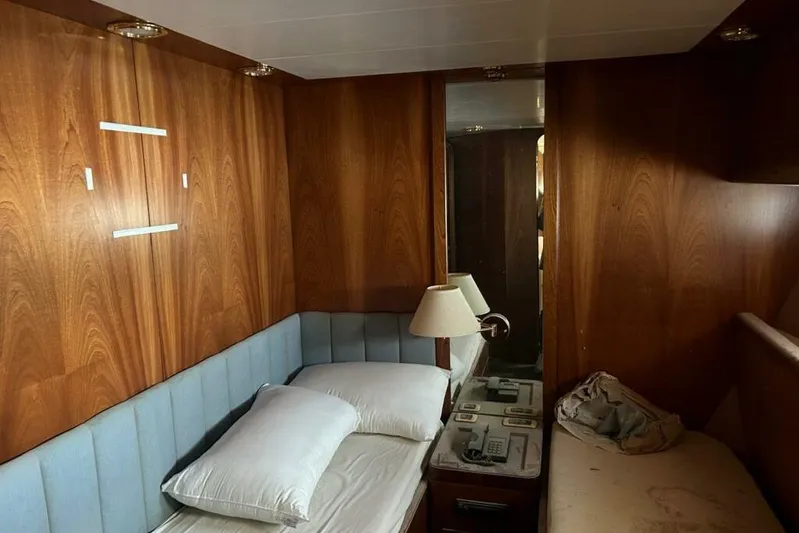  Yacht Photos Pics Cozy cabin interior of 1998 Sanlorenzo 82 yacht with wood paneling and twin beds.