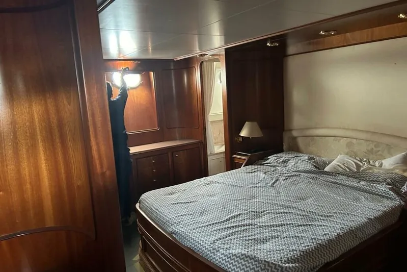  Yacht Photos Pics Luxurious wooden cabin interior of 1998 Sanlorenzo 82 yacht with bed and lighting.