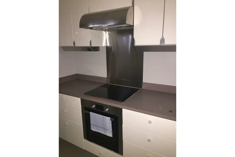  Yacht Photos Pics Modern kitchen in 1998 Sanlorenzo 82 yacht with sleek cabinetry and stainless steel appliances.