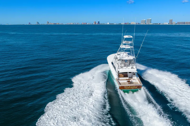 Unleashed Yacht Photos Pics 2007 Viking 56 Convertible yacht cruising on open blue ocean.