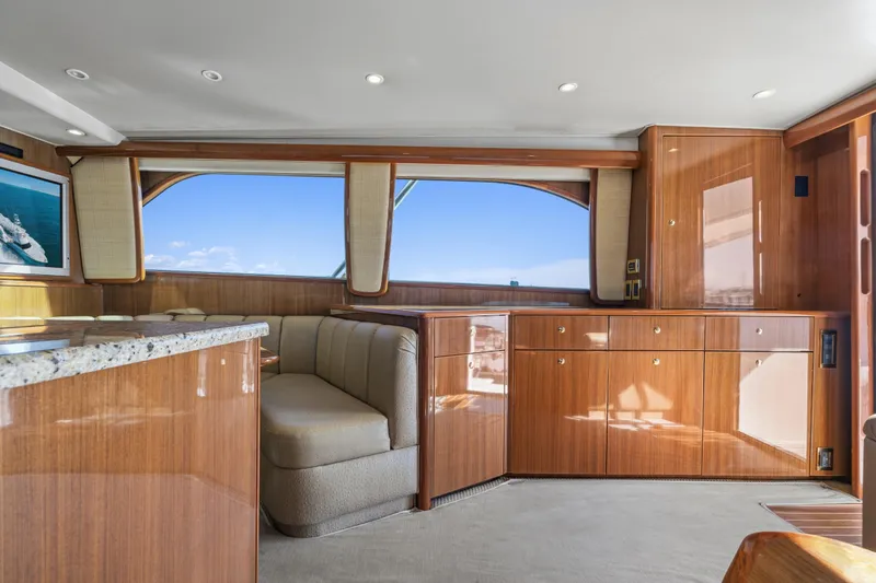 Unleashed Yacht Photos Pics Luxurious interior of 2007 Viking 56 Convertible yacht with polished wood and plush seating.