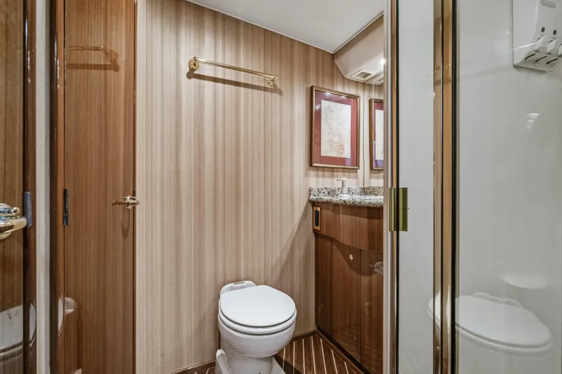 Unleashed Yacht Photos Pics Luxurious bathroom in 2007 Viking 56 Convertible yacht with wood accents and granite countertop.