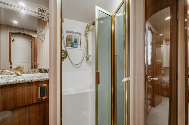 Unleashed Yacht Photos Pics Luxurious bathroom in 2007 Viking 56 Convertible yacht with granite countertop and glass shower.