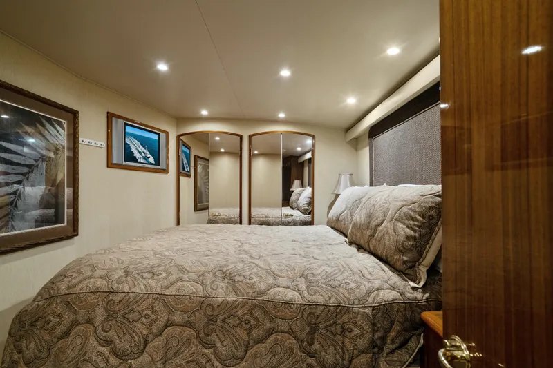 Unleashed Yacht Photos Pics Luxurious bedroom interior of 2007 Viking 56 Convertible yacht with elegant decor and lighting.