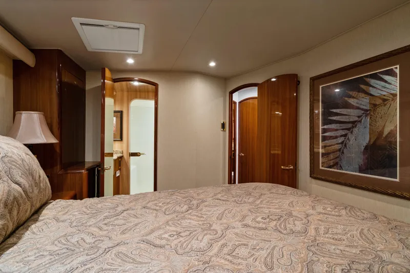 Unleashed Yacht Photos Pics Luxurious bedroom interior of 2007 Viking 56 Convertible yacht with elegant decor and artwork.