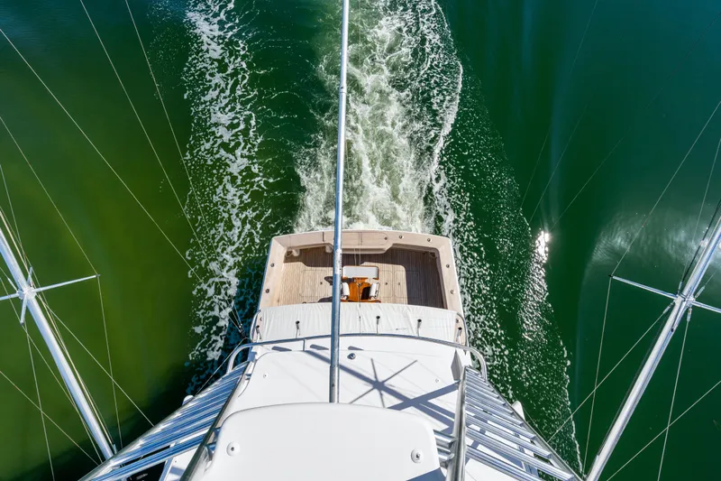 Unleashed Yacht Photos Pics Aerial view of 2007 Viking 56 Convertible yacht cruising on green water.