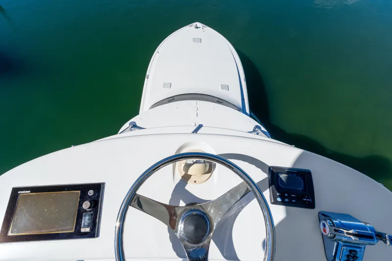 Unleashed Yacht Photos Pics Helm view of 2007 Viking 56 Convertible yacht with steering wheel and controls.