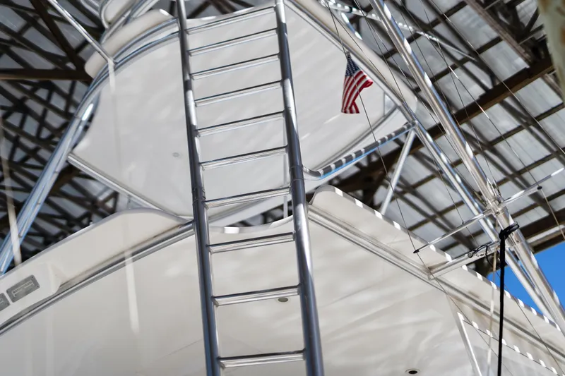 Unleashed Yacht Photos Pics 2007 Viking 56 Convertible yacht ladder with American flag under a metal roof.