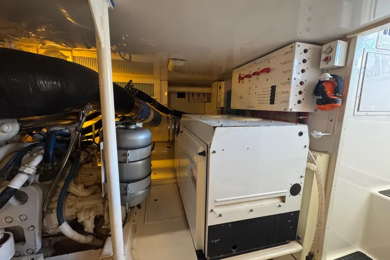 Unleashed Yacht Photos Pics Engine room of a 2007 Viking 56 Convertible yacht, showcasing machinery and control panels.