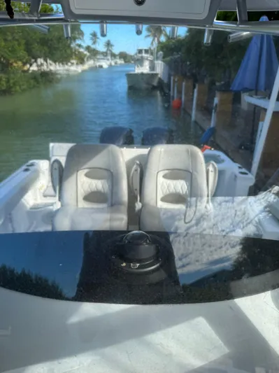  Yacht Photos Pics 2020 Sea Fox 288 Commander boat with dual seats, docked in a serene waterway.