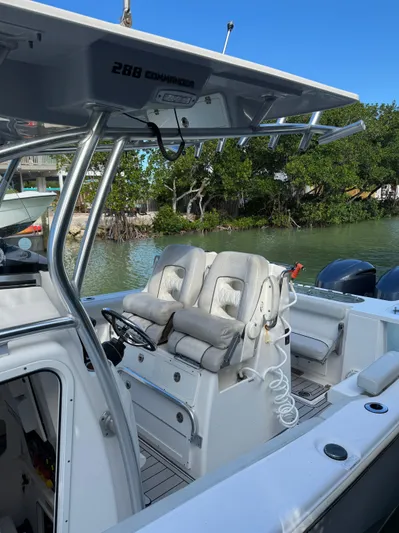  Yacht Photos Pics 2020 Sea Fox 288 Commander boat with dual seating, docked near lush greenery.