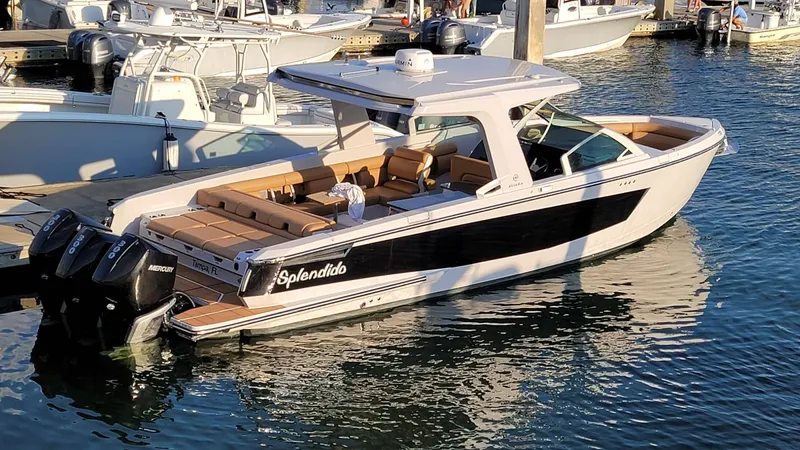  Yacht Photos Pics 2021 Aviara AV36 OB boat docked in marina, featuring sleek design and twin outboard engines.