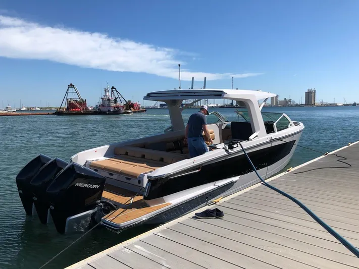  Yacht Photos Pics 2021 Aviara AV36 OB boat docked, featuring sleek design and powerful Mercury outboard engines.