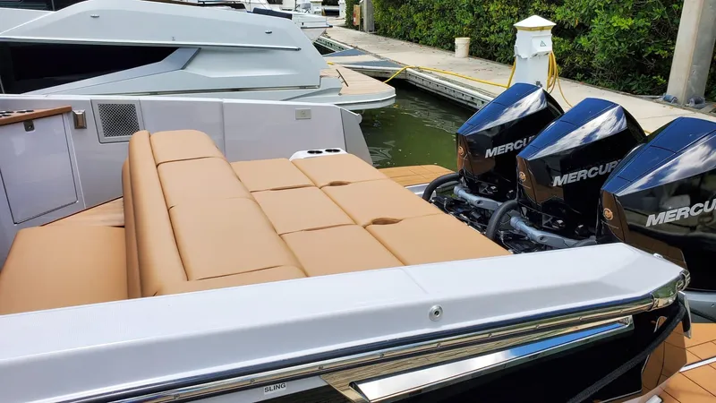  Yacht Photos Pics 2021 Aviara AV36 OB boat with tan seating and Mercury outboard engines at a dock.