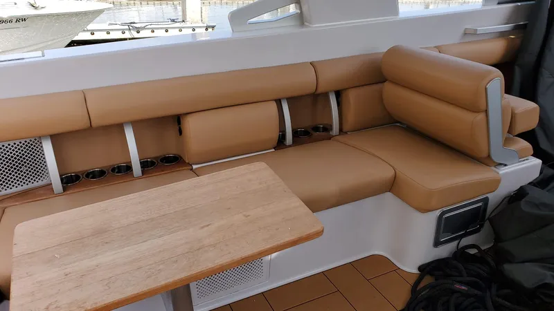  Yacht Photos Pics 2021 Aviara AV36 OB boat interior with tan leather seating and wooden table.