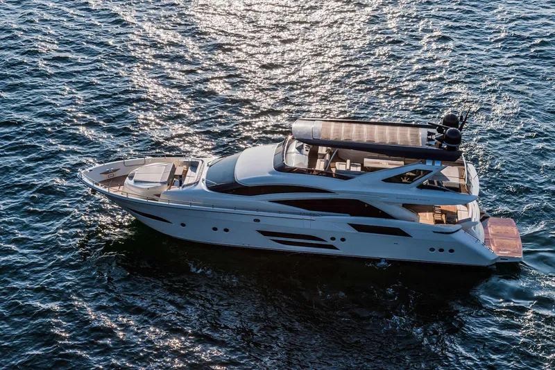  Yacht Photos Pics Luxurious 2015 Dominator 800 yacht cruising on shimmering blue water.