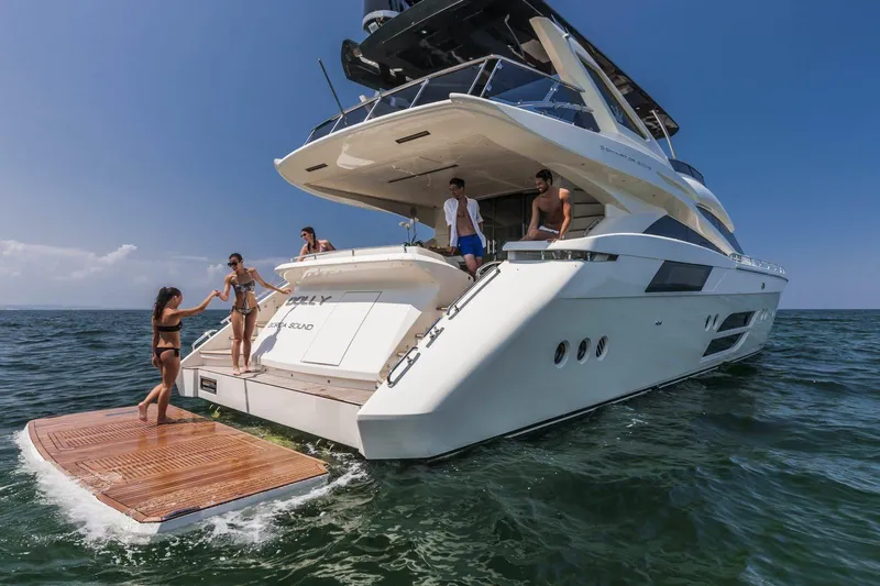  Yacht Photos Pics Luxurious 2015 Dominator 800 yacht with people enjoying the sun on the deck.
