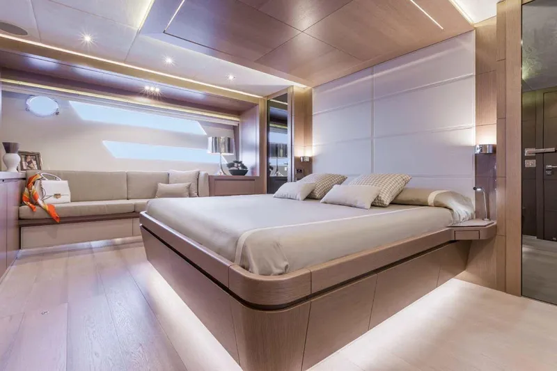  Yacht Photos Pics Luxurious bedroom interior on a 2015 Dominator 800 yacht, featuring modern design and ambient lighting.