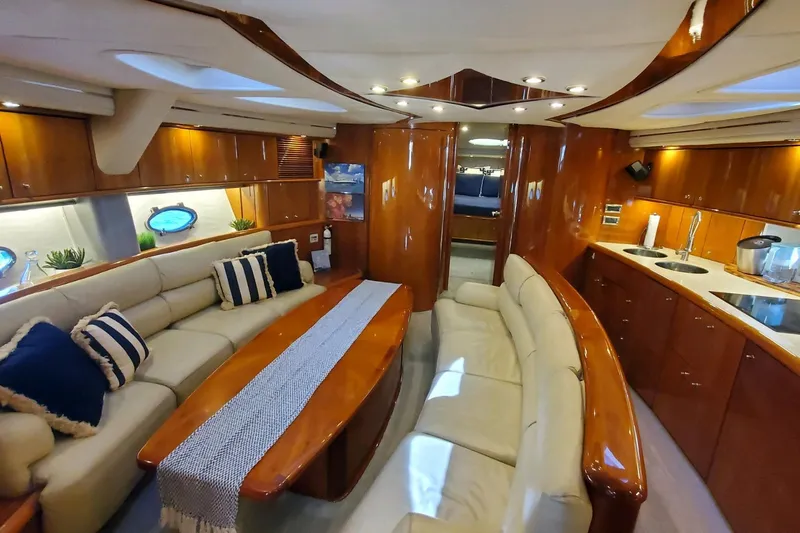 Vintage Yacht Photos Pics Luxurious interior of 1999 Sunseeker Predator 75 yacht with elegant seating and wood finishes.