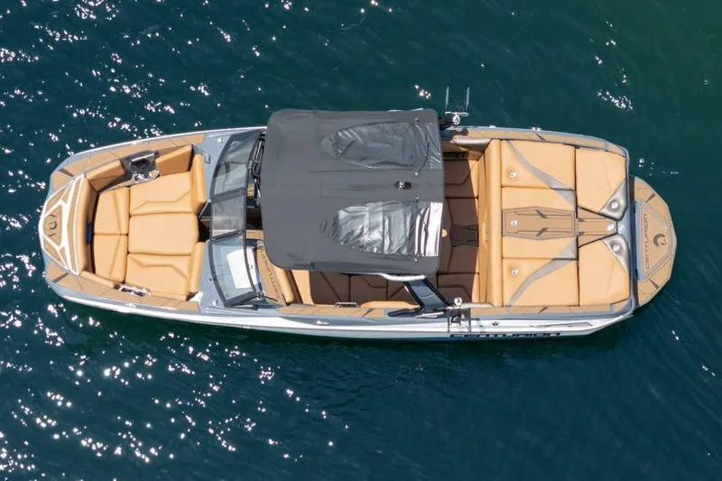  Yacht Photos Pics Aerial view of 2025 Centurion Nv233 boat with tan seating on blue water.