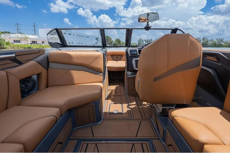  Yacht Photos Pics Luxurious interior of 2025 Centurion Nv233 boat with tan leather seating.