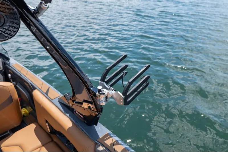  Yacht Photos Pics Centurion Nv233 2025 boat with wakeboard rack on calm water.