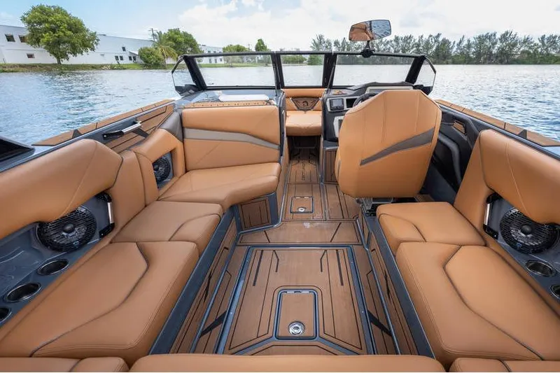  Yacht Photos Pics Luxurious interior of 2025 Centurion Nv233 boat with tan leather seating and modern design.