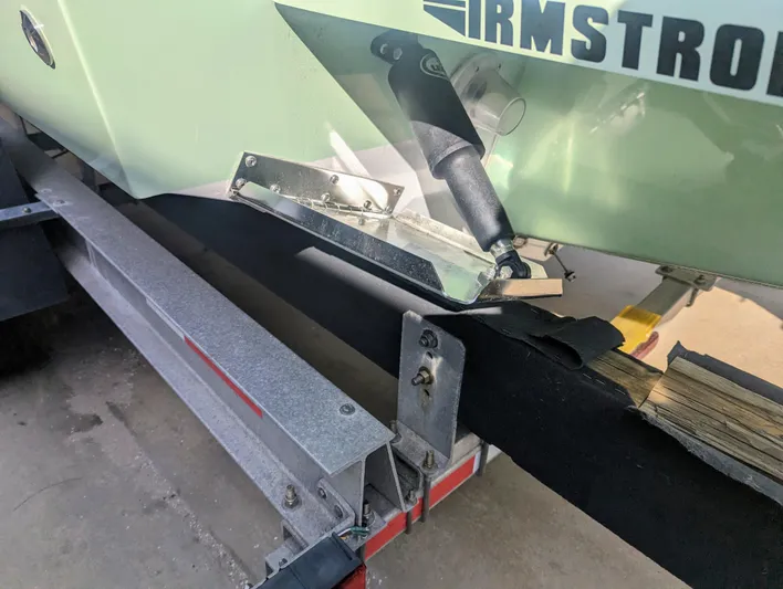  Yacht Photos Pics 2023 Bluewater Sportfishing 23t boat on trailer, close-up of hull and trim tab.