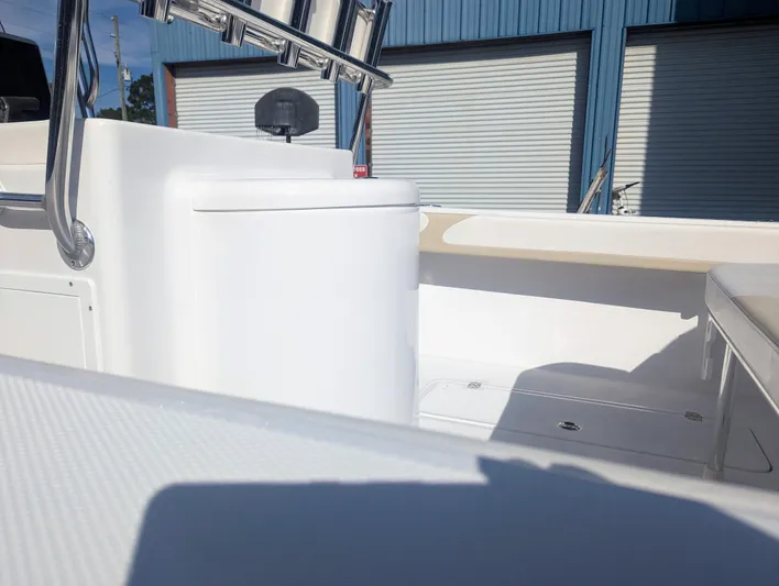  Yacht Photos Pics 2023 Bluewater Sportfishing 23t boat interior with sleek white console and storage compartments.