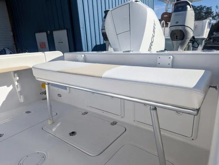  Yacht Photos Pics 2023 Bluewater Sportfishing 23t boat interior with seating and twin outboard engines.