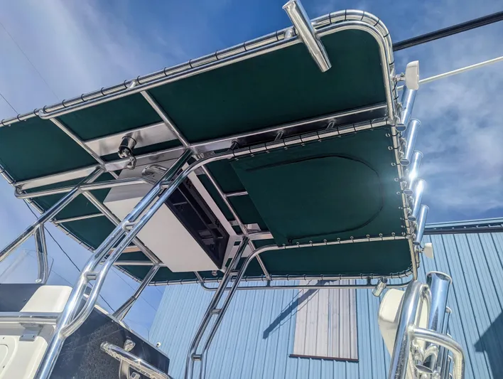  Yacht Photos Pics 2023 Bluewater Sportfishing 23t boat with green canopy and metal frame.