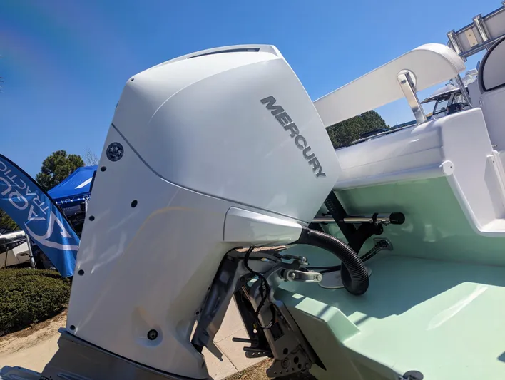  Yacht Photos Pics 2023 Bluewater Sportfishing 23t boat with Mercury outboard motor, displayed outdoors.